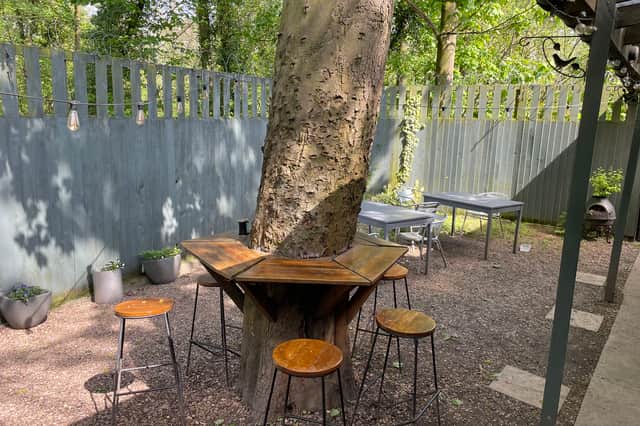 The enclosed garden is quieter than you'd expect sitting next to a busy road.