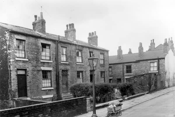 Three brick built terraced houses on Haymount Street in an area of Newtown designated for clearance. An ancient pram almost buckles under the weight of bundles of chips obviously being sold around the streets for fire lighters. this area is now part of the Lincoln Green estate. Pictured in October 1958.