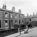 Three brick built terraced houses on Haymount Street in an area of Newtown designated for clearance. An ancient pram almost buckles under the weight of bundles of chips obviously being sold around the streets for fire lighters. this area is now part of the Lincoln Green estate. Pictured in October 1958.