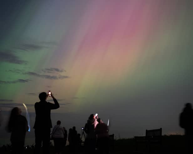 People visit St Mary's lighthouse in Whitley Bay to see the aurora borealis on 10 May 2024 (Photo: Ian Forsyth/Getty Images)