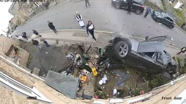 Dramatic moment speeding car ploughs into house before occupants flee scene