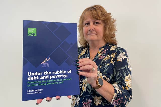Helen Bolton, of Christians Against Poverty, with the report launched by the charity for 2024. Photo: National World.