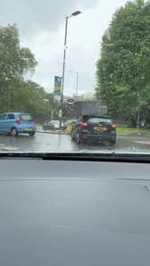 Sofa flies off roof of car and onto busy roundabout.