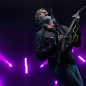 Josh Homme performing at Roskilde Festival 2023. Queens of the Stone Age are set to headline Friday night at Download Festival 2024 - but what could they play and what merchandise could be for sale at the festival? (Credit: Getty Images)