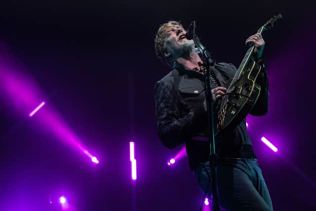 Josh Homme performing at Roskilde Festival 2023. Queens of the Stone Age are set to headline Friday night at Download Festival 2024 - but what could they play and what merchandise could be for sale at the festival? (Credit: Getty Images)