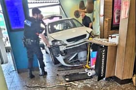 Man injured as car crashes into busy McDonalds