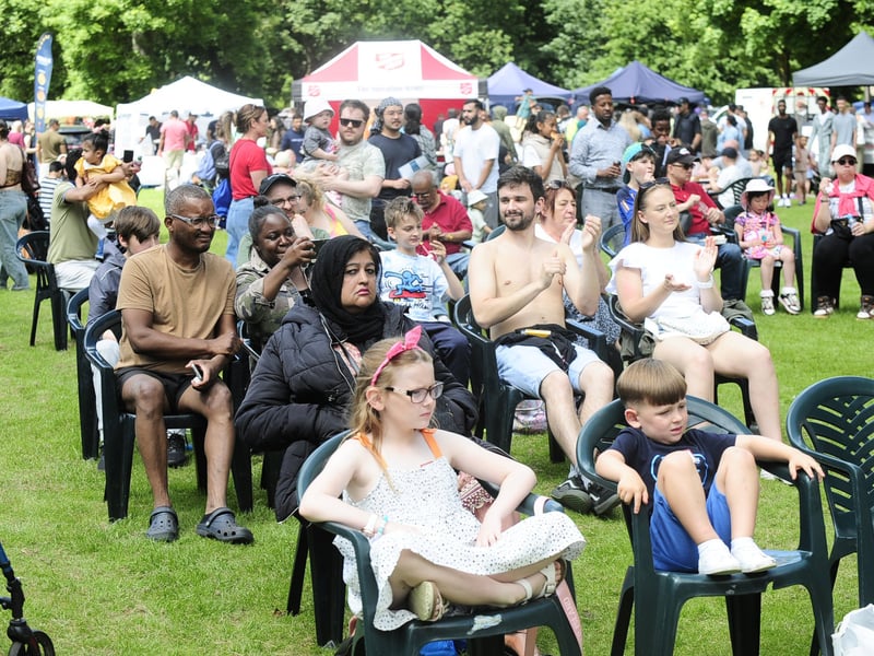 A large crowd watch the performers on stage.