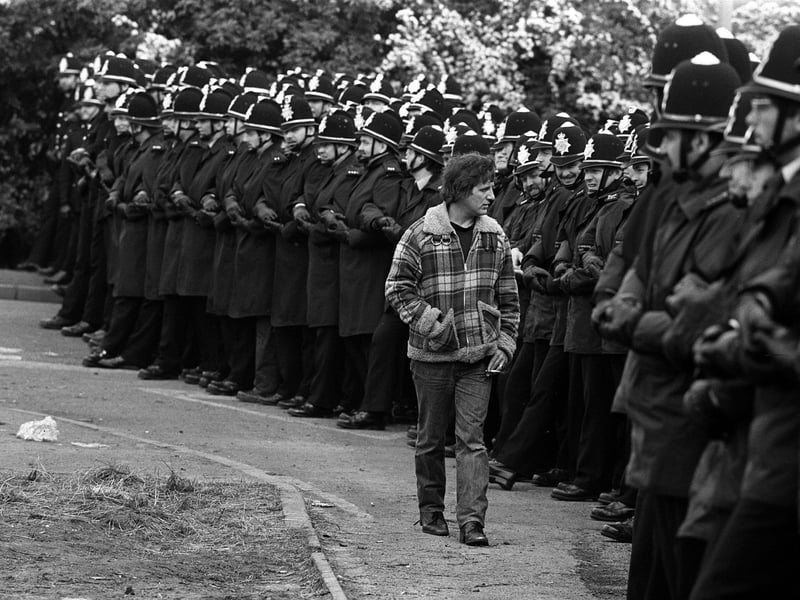 A picket inspects a line of police officers outside the Orgreave coking plant in June 1984.