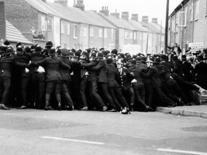 A line of police contains pickets in a side street opposite Allerton Bywater Colliery in August 1984.