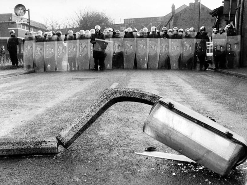 Wheldale Colliery became a blazing scrapyard in November 1984 as frustrated pickets renewed their struggle to save the strike at the pit. Pictured are police in riot gear near a smashed street lamp.