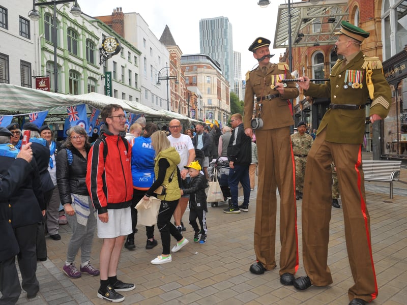 Characters entertain the crowds in Briggate.