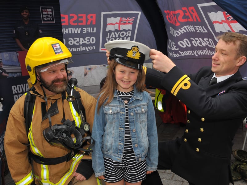 Matilda Morton, six, of Birkenshaw with Leeds based HMS Ceres Royal Naval Reserve Petty Officer Rob Kendrick and Lt Phill Corner.