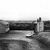 The junction of Oldfield Lane and Elmfield Grove, with houses at either side. To the right is the edge of Wortley Recreation Ground. Pictured in January 1983.