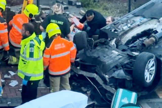 Footage of the aftermath of a car crash that left two pedestrians hospitalised shows a man being pulled from the wreckage.  