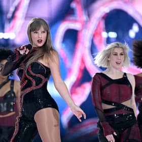 Taylor Swift onstage during the Eras Tour in her Reputation costume.
