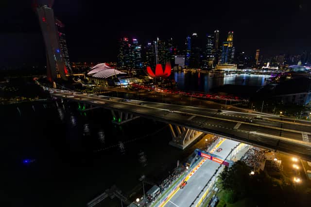 Carlos Sainz of Spain driving (55) the Ferrari SF-23 leads Charles Leclerc of Monaco driving the (16) Ferrari SF-23 during the F1 Grand Prix of Singapore September 17, 2023.