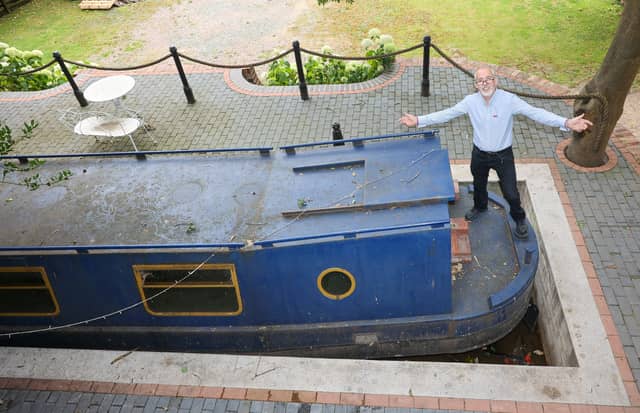 Stephen Cuddy with the mini canal lock he built to house a narrowboat turned into a swimming pool.