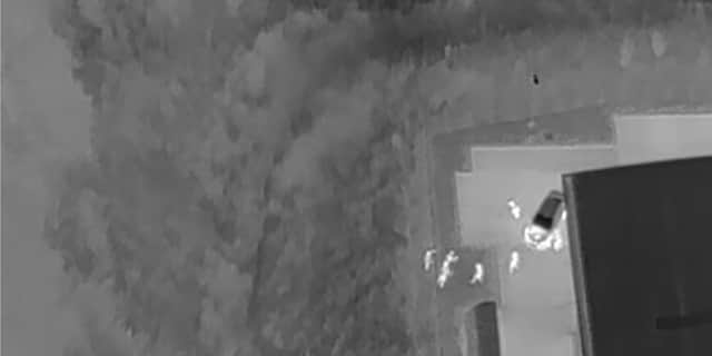 Suspects located by drone in dark undergrowth.