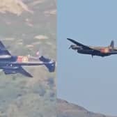 Second World War-era Avro Lancaster Bomber flies over lake.
