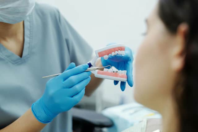 A dentist shows a patient how braces would look on the teeth. (Photo: Pexels/Cedric Fauntleroy)