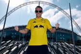 Leeds United fan and former world champion boxer Josh Warrington sports the club's yellow away shirt on the steps outside Wembley Stadium 