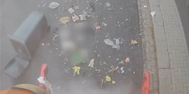Item in bin explodes sending its contents flying.