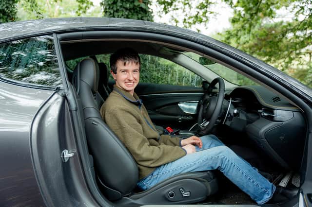 21-year-old Asda worker Jasper Hemsworth with the £160k Maserati he won in an Omaze prize draw.