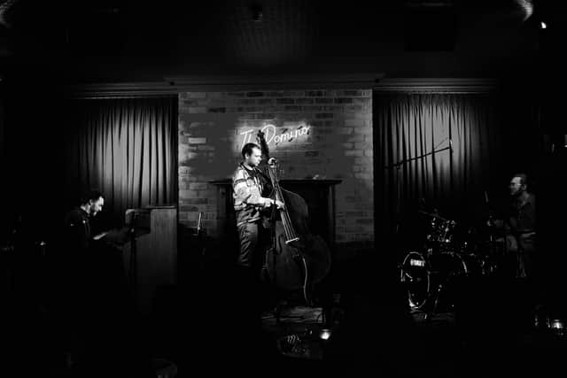 Fergus Quill (centre) has played at The Domino Club over 500 times.