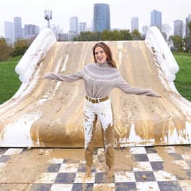 Binky Felstead encourages families to embrace the mud this half term as she's spotted going down a 2.5m high mudslide, created by Bosch at Mudchute Farm. 