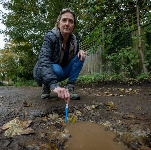 Resident Sarah Wright on Whitebarns Lane in the village of Furneaux Phelham in Hertfordshire, which has 32 potholes.