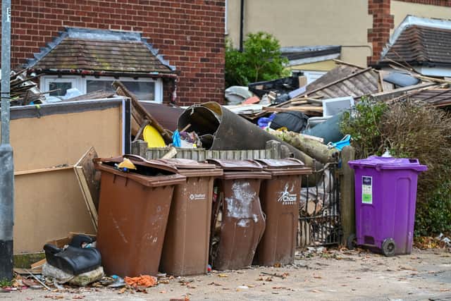 Shocking photos show piles of debris stacked up on the driveway - including rubble, sofas, mattresses, wooden panels, fridges and carpets.