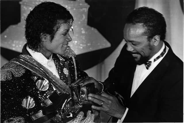 Michael Jackson, left, with Quincy Jones with armful of Grammys at the award show Feb. 28, 1984
