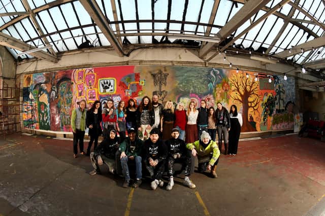 The team behind the huge painting. Members of the public were also invited to help paint the canvas too.