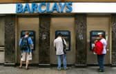 Commuters withdraw cash from ATMs outside a branch of Barclays Bank in London (Photo: Sion Touhig/Getty Images)