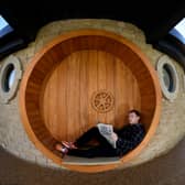 AirB&B host Mike Afflick reads his Lancashire Post while taking a break at his Hobbit House in Inglewhite, near Preston. 
