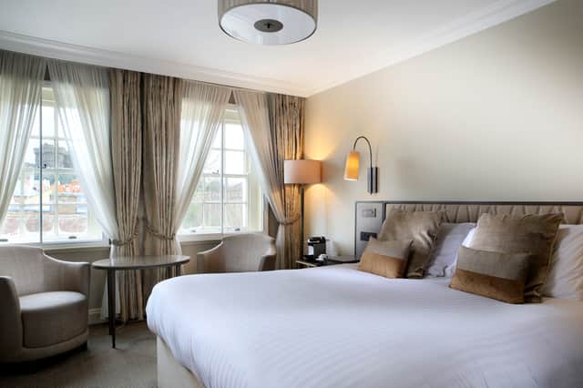 A deluxe queen bedroom with a view of Windsor Castle. Credit: The Castle Hotel