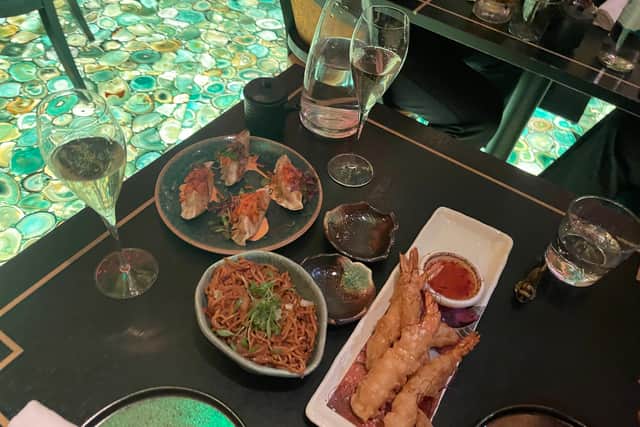 We enjoyed the pork and kimchi gyoza, top left, the chilli noodles and the ebi prawn tempura nahm jim alongside two glasses of Veuve Cliquot.