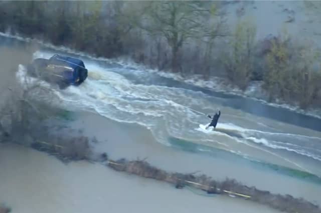 Man wakeboards along flooded road in Leicestershire.