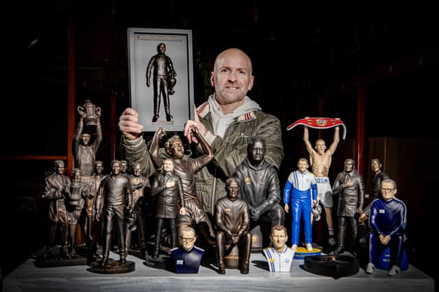 Tony Clark with his sculptures of Leeds United legends.