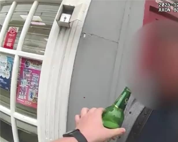 Man tries to take swig of his lager while being arrested for drink driving.