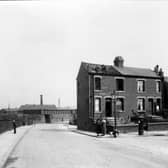 Nursery Mount Road, off Belle Isle Road in May 1938. On the left is an embankment carrying the Hunslet branch line of LNER, with a metal bridge over the road. The factory beyond is the Cooperative Wholesale Society brush factory. Two workmen are removing slates from the roof of number 1.