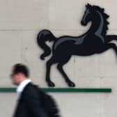 A man passes the entrance to a Lloyds Banking Group office in the City of London (Photo: JUSTIN TALLIS/AFP via Getty Images)