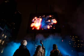 Visuals of a blue whale, northern lights, and football tricks are displayed in a hologram show over London