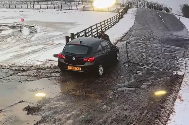 The moment Alan Lewis drove off with the staff member on the bonnet of the car. Credit: Mainsgill Farm Shop