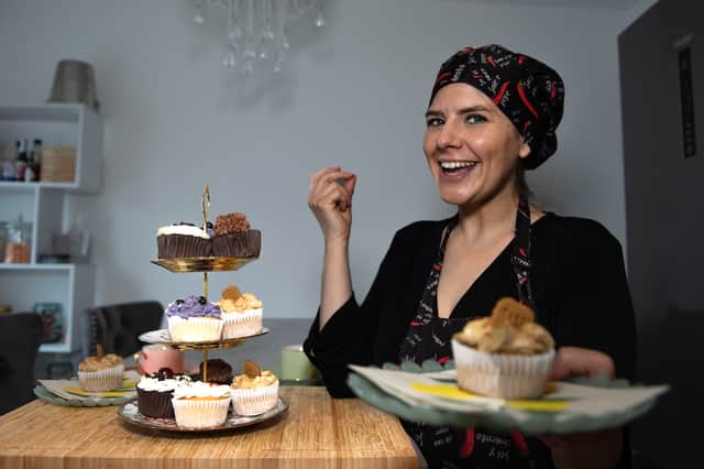 Photo of business owner with vegan cupcakes