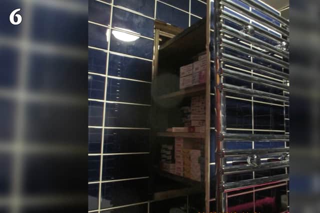 Officers also discovered thousands of fake cigarettes hidden in a secret compartment behind a bathroom towel rail.