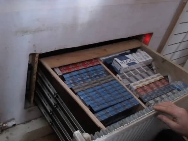 Criminals had built a secret room behind a fake radiator which hid a deep drawer full of illegal tobacco products. 