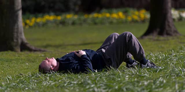A man lies in the sun.