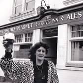 CHEERS!: Kathleen Longbottom, joint licensee of The Grove Inn,  toasts winning the CAMRA Pub of the Season Award in May 1991.