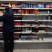 An employee stocks shelves at a Tesco supermarket in central London in 2021 (Photo: JUSTIN TALLIS/AFP via Getty Images)